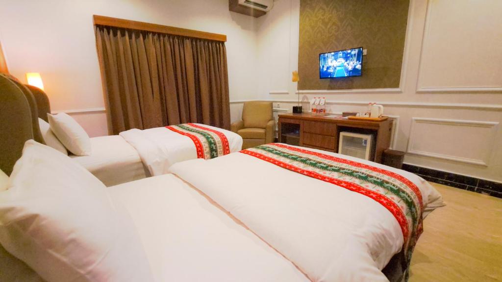 Postel nebo postele na pokoji v ubytování Gili Beachfront Suites