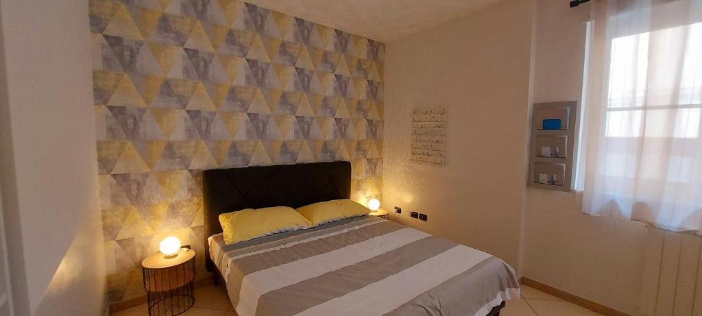 a bedroom with a bed and a wall with a fireplace at Casa vacanze Fantasia - Nuovo! Accogliente appartamento in Barletta
