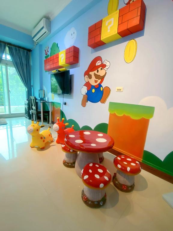 a room with a toy room with a table and mushrooms at Hualien Lidu House in Hualien City