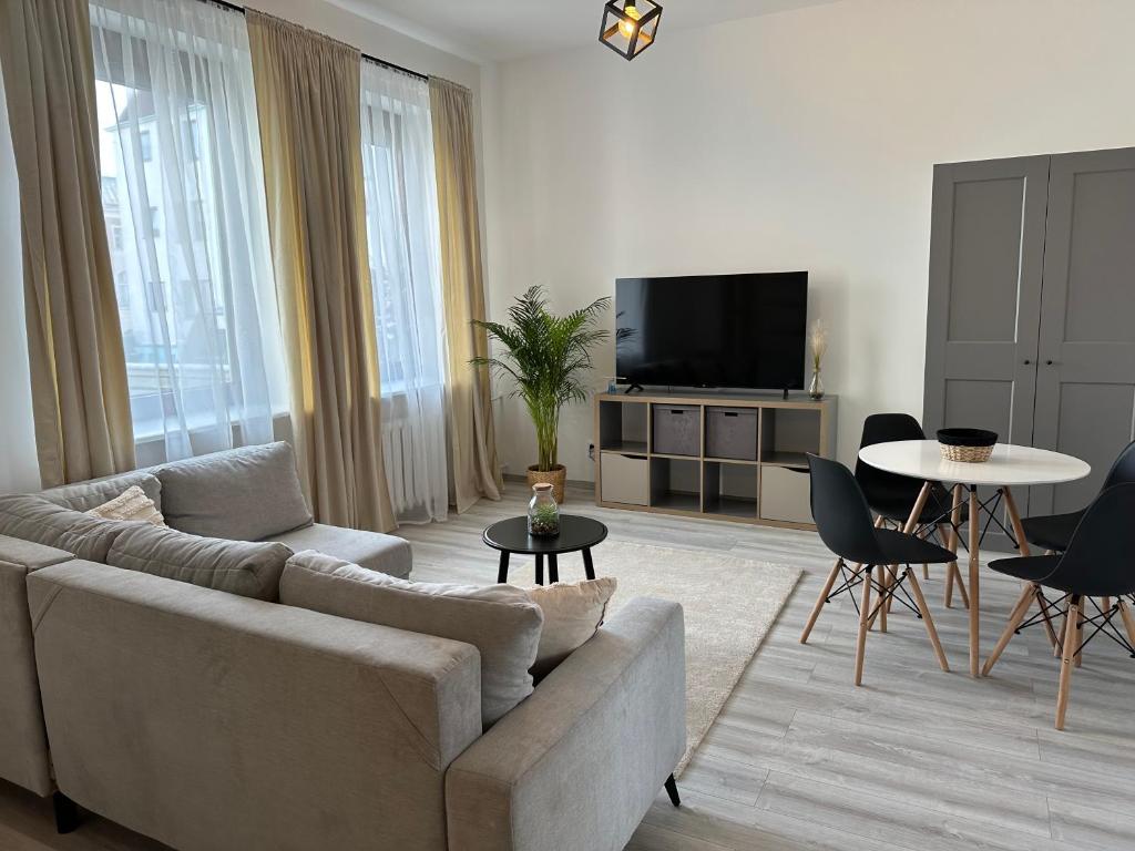 a living room with a couch and a table at Apartamenty Przy Deptaku in Świnoujście