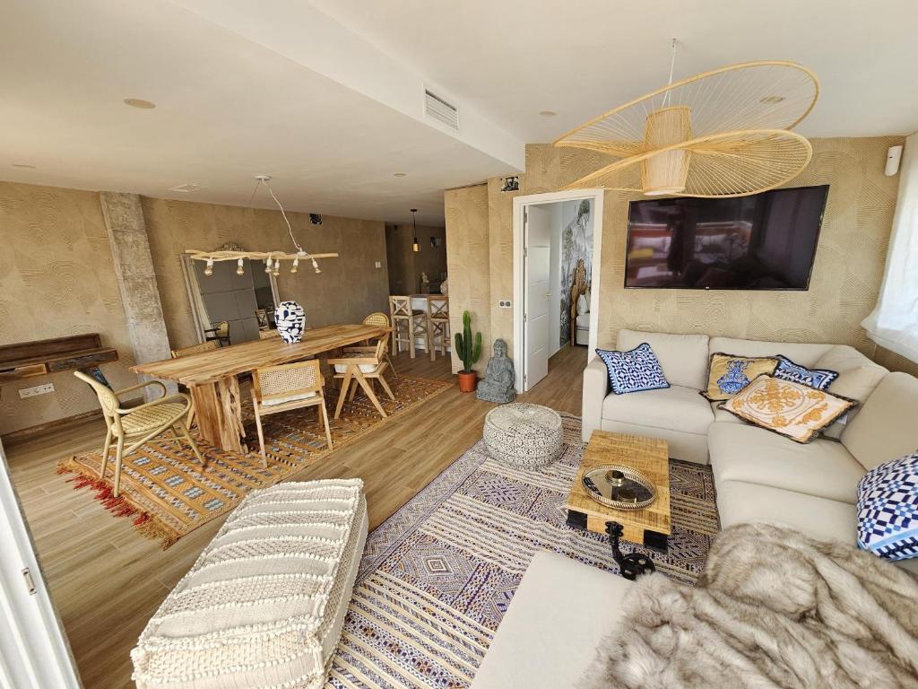 a living room with a couch and a table at La Sardina de Denia in Denia