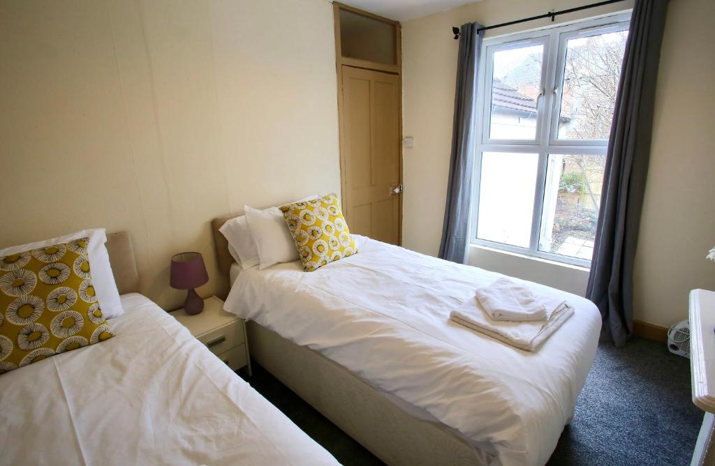 a bedroom with two beds and a window at Albemarle House in Taunton