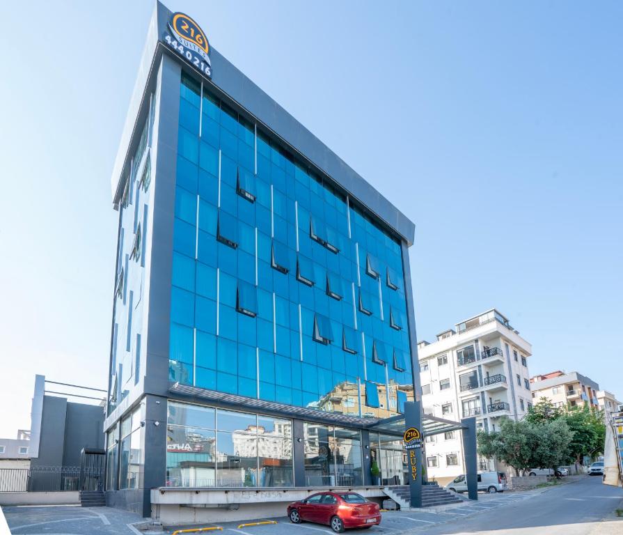 a red car parked in front of a blue building at 216 Ruby Suite in Istanbul