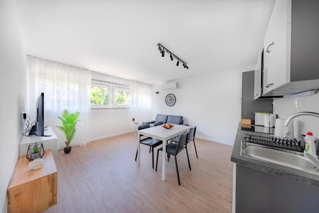 a kitchen and living room with a table and chairs at Apartment Fani with free private parking in Dubrovnik