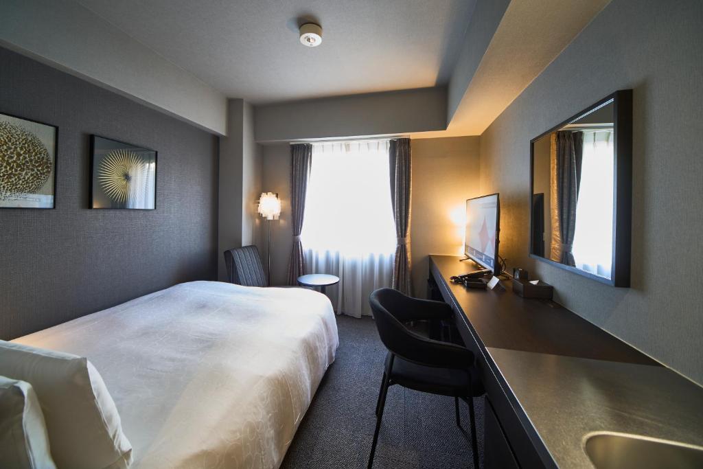 Postel nebo postele na pokoji v ubytování Roppongi Hotel S