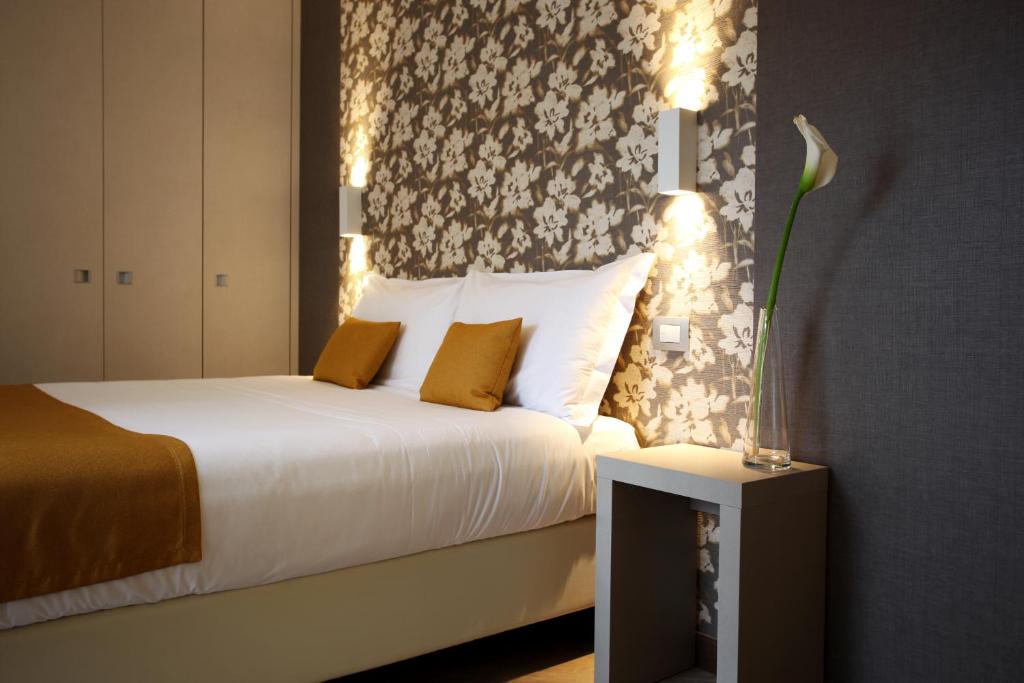 Postel nebo postele na pokoji v ubytování Hotel Ponti