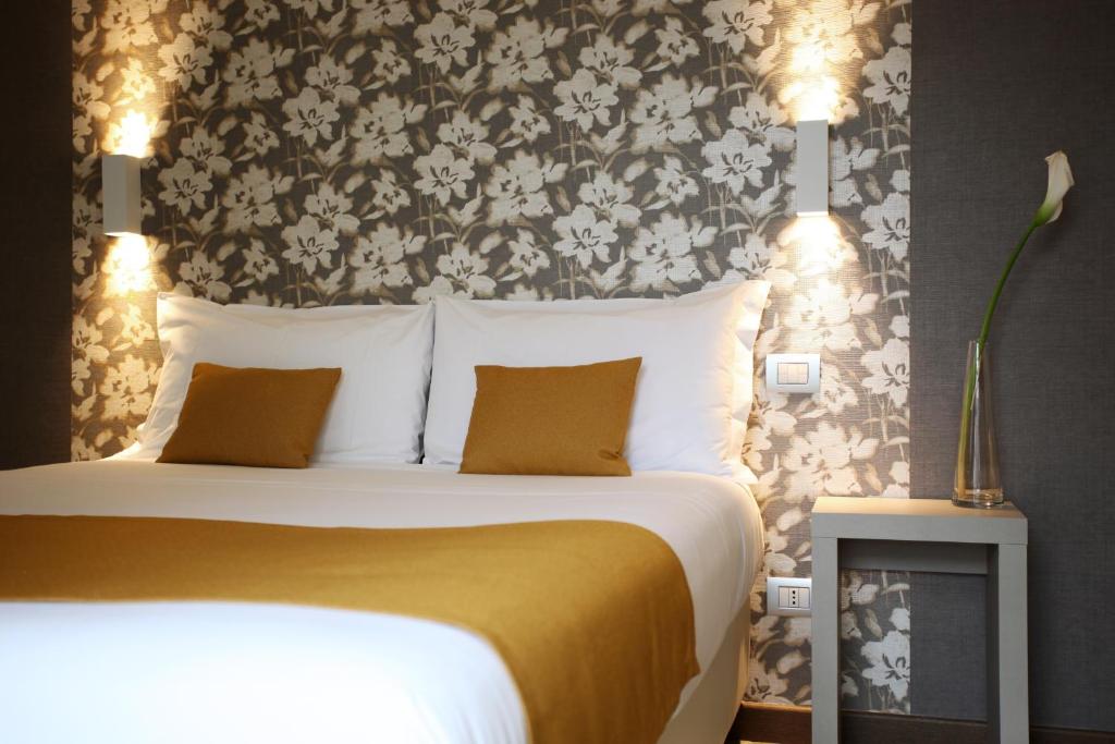 Postel nebo postele na pokoji v ubytování Hotel Ponti