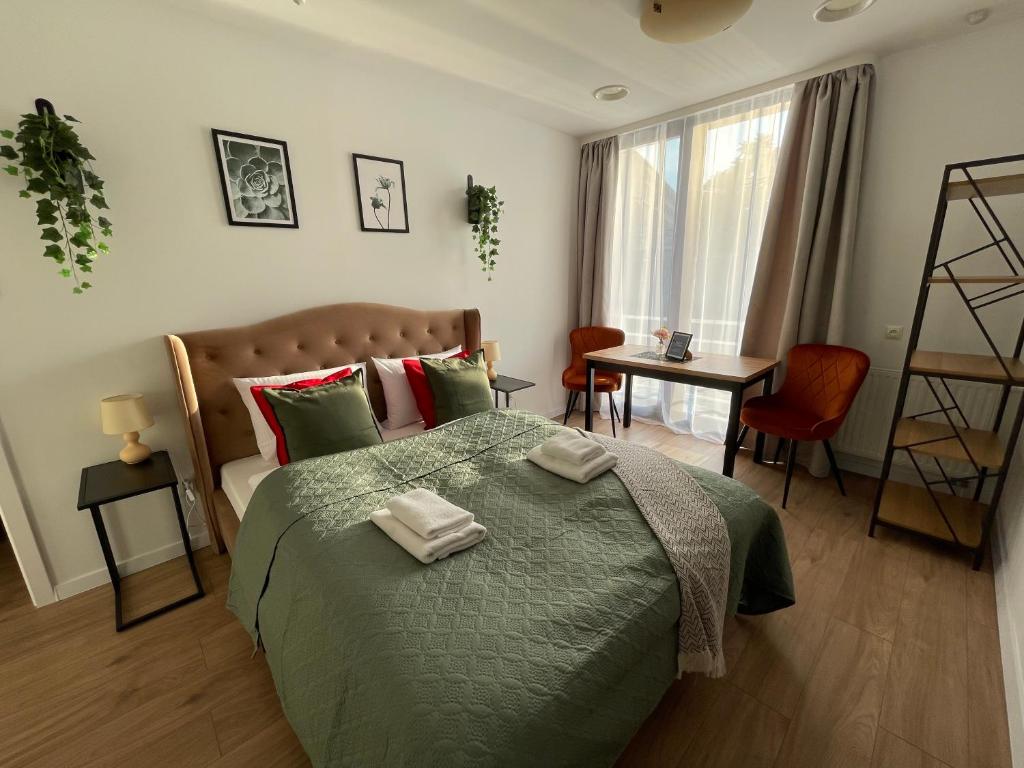 a bedroom with a bed with two towels on it at Great Polonia Wrocław Tumski in Wrocław