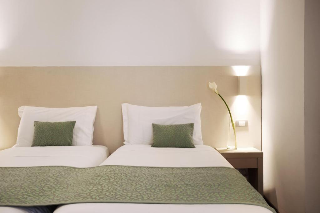 Postel nebo postele na pokoji v ubytování Hotel Ponti