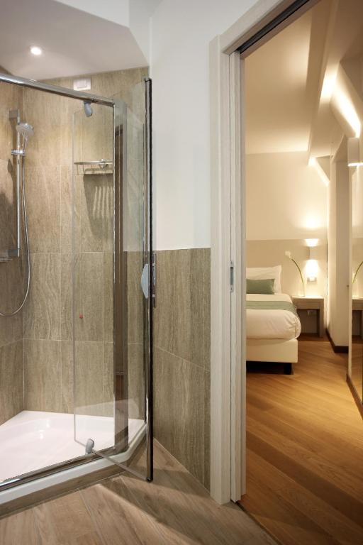 Postel nebo postele na pokoji v ubytování Hotel Ponti