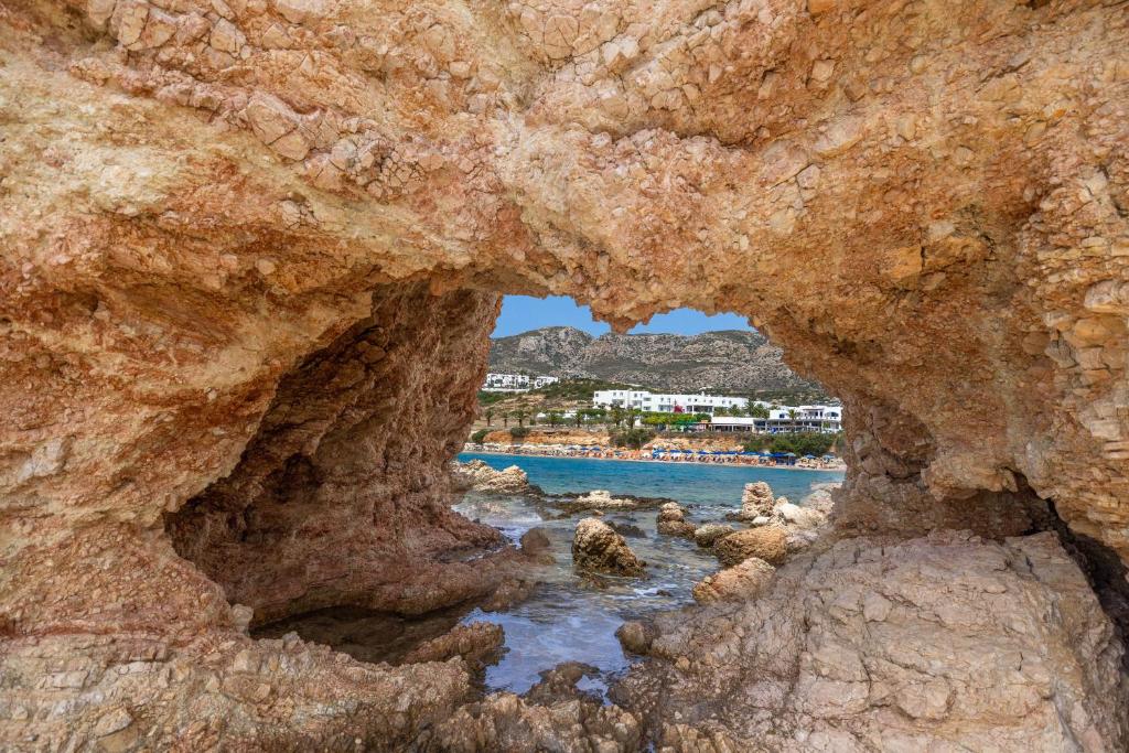 a view of the water through a rock cave at Cavo Marelia in Amoopi