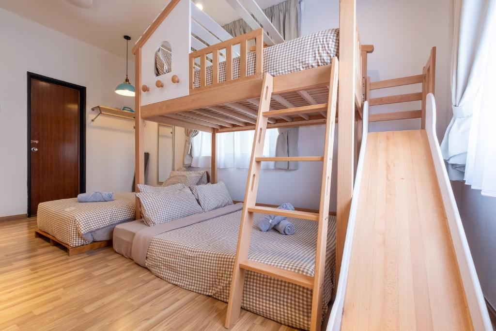 a bedroom with a bunk bed and a ladder at Kids Dream Home with Slides 4Bedroom2Bath 14pax LRT in Kuala Lumpur