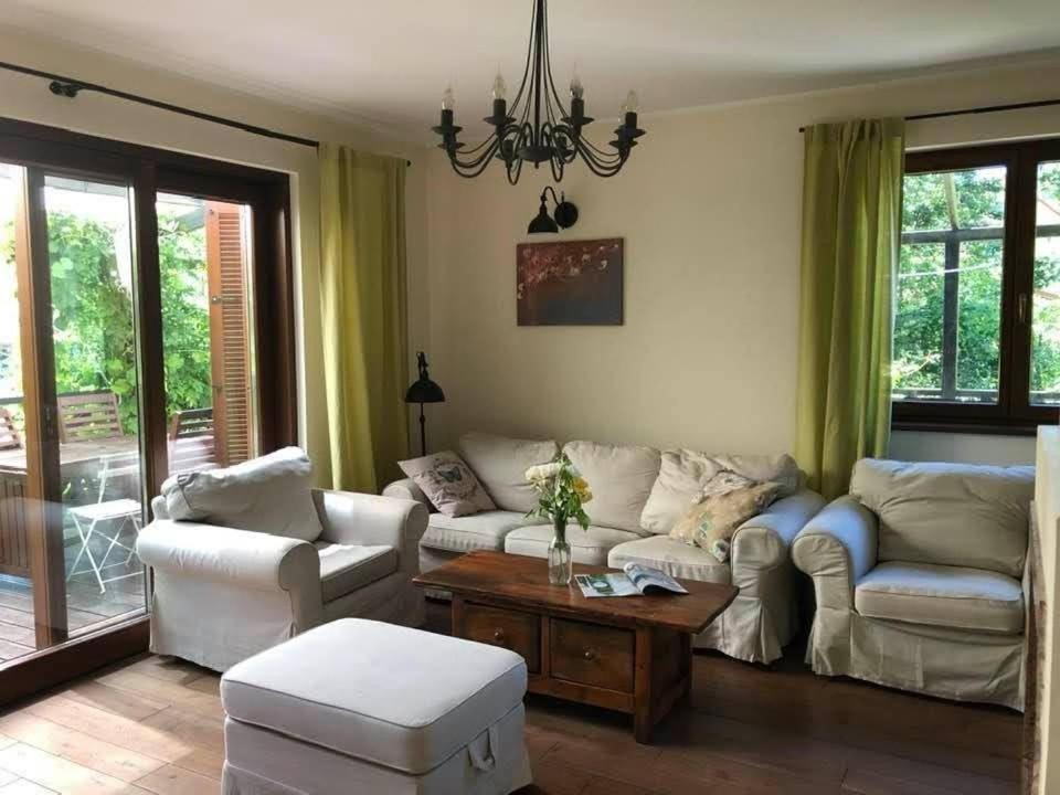 a living room with two couches and a table at Leśna 6 - House with a garden in Bolechowice