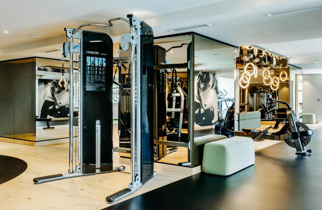 a gym with several treadmills and machines at Grand Tirolia Kitzbühel - Member of Hommage Luxury Hotels Collection in Kitzbühel
