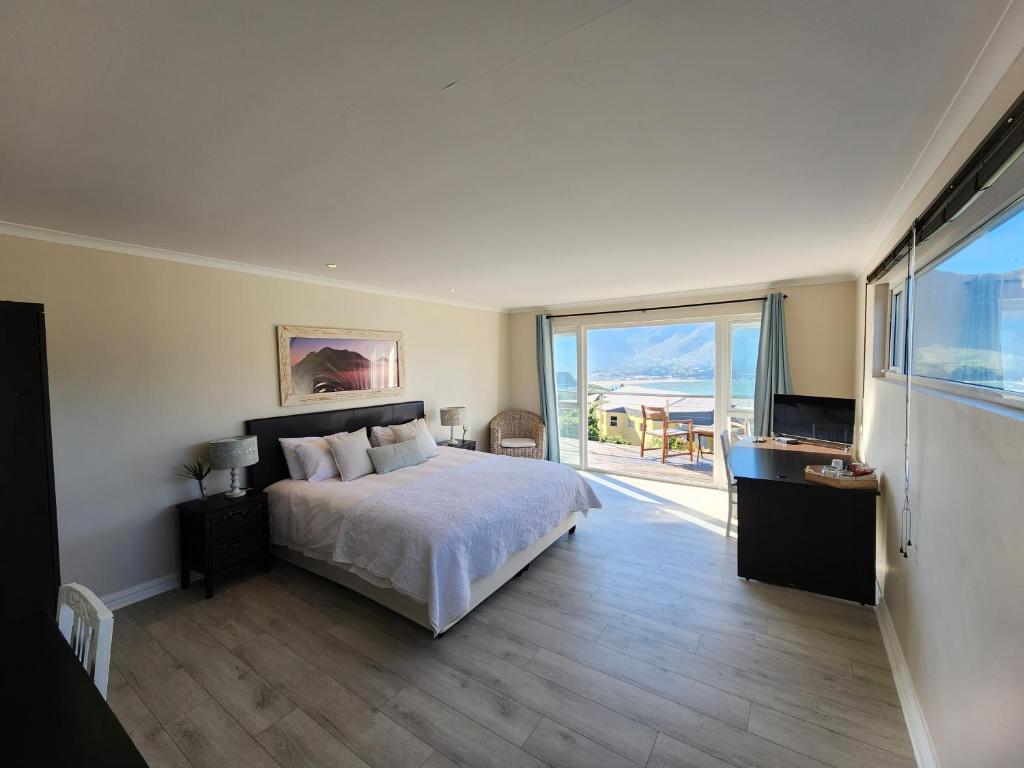 a bedroom with a bed and a view of the ocean at Hout Bay Breeze in Hout Bay