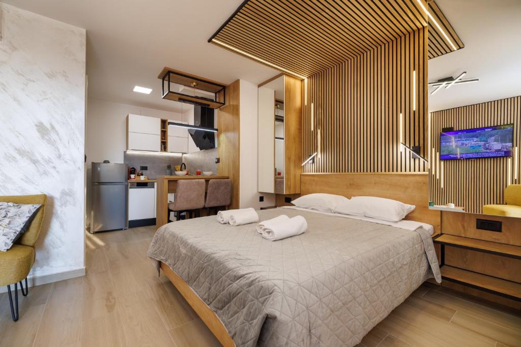 a bedroom with a bed with two towels on it at La Vista apartments in Salatić