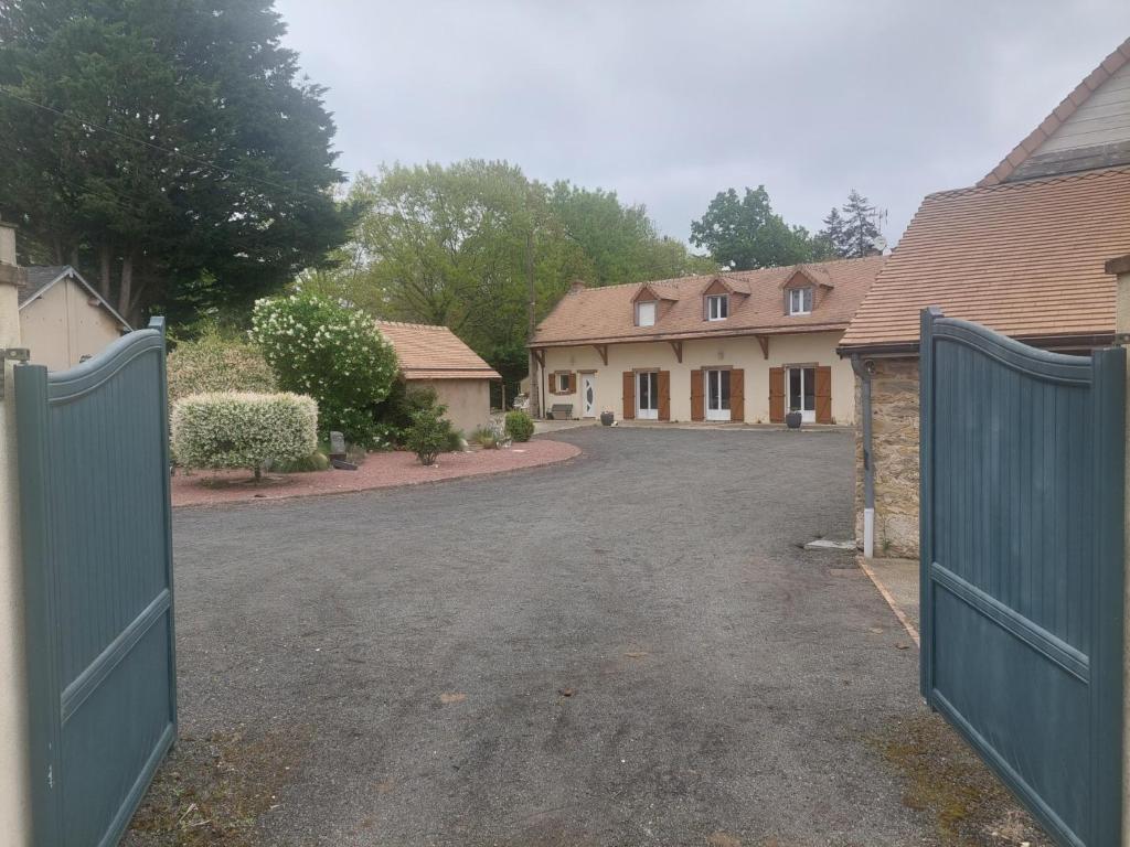 une allée avec un portail en face d'une maison dans l'établissement Chambre a proximité du circuit des 24 heures, à Guémardières