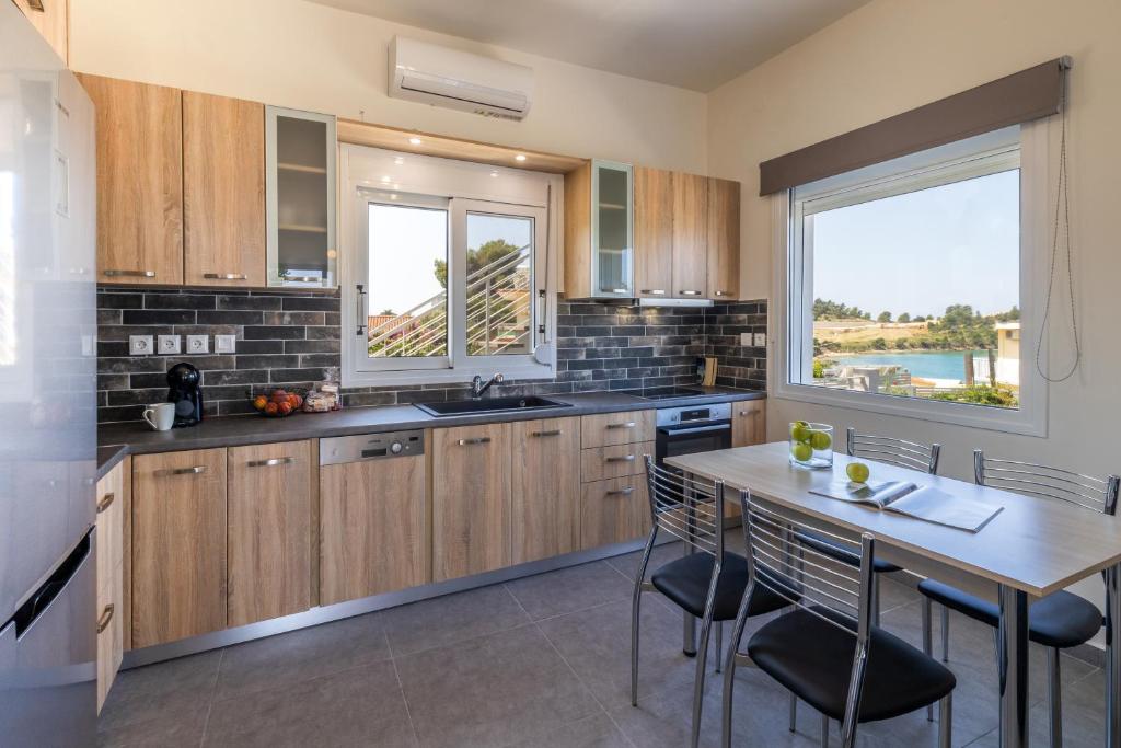 a kitchen with wooden cabinets and a table with chairs at Amy's Seaside Oasis in Argostoli