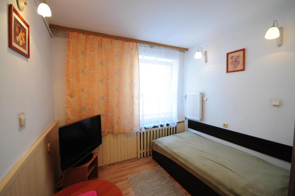 Posteľ alebo postele v izbe v ubytovaní Hotel Wysoka Brama