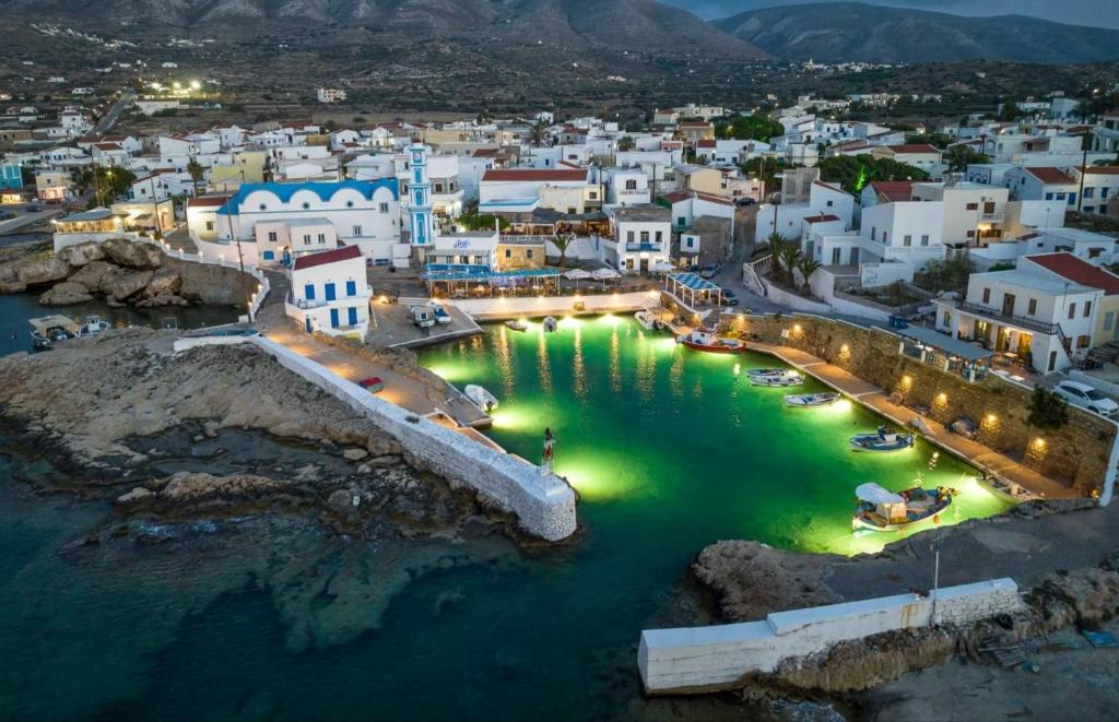 an aerial view of a town with lights in the water at Hotel Anagennisis in Frý