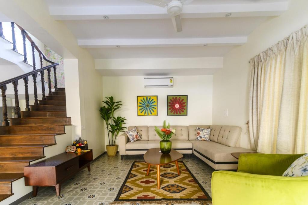 a living room with a couch and a table at Eerus Villa 3Bhk Luxurious Home in Arpora