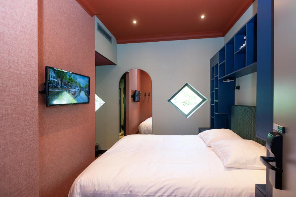 Postel nebo postele na pokoji v ubytování Hotel Nicolaas Witsen