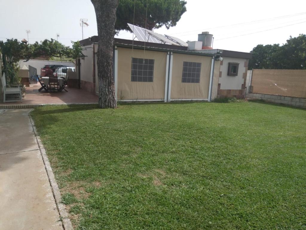 a house with a yard with a tree in it at Almajar 4 in El Puerto de Santa María