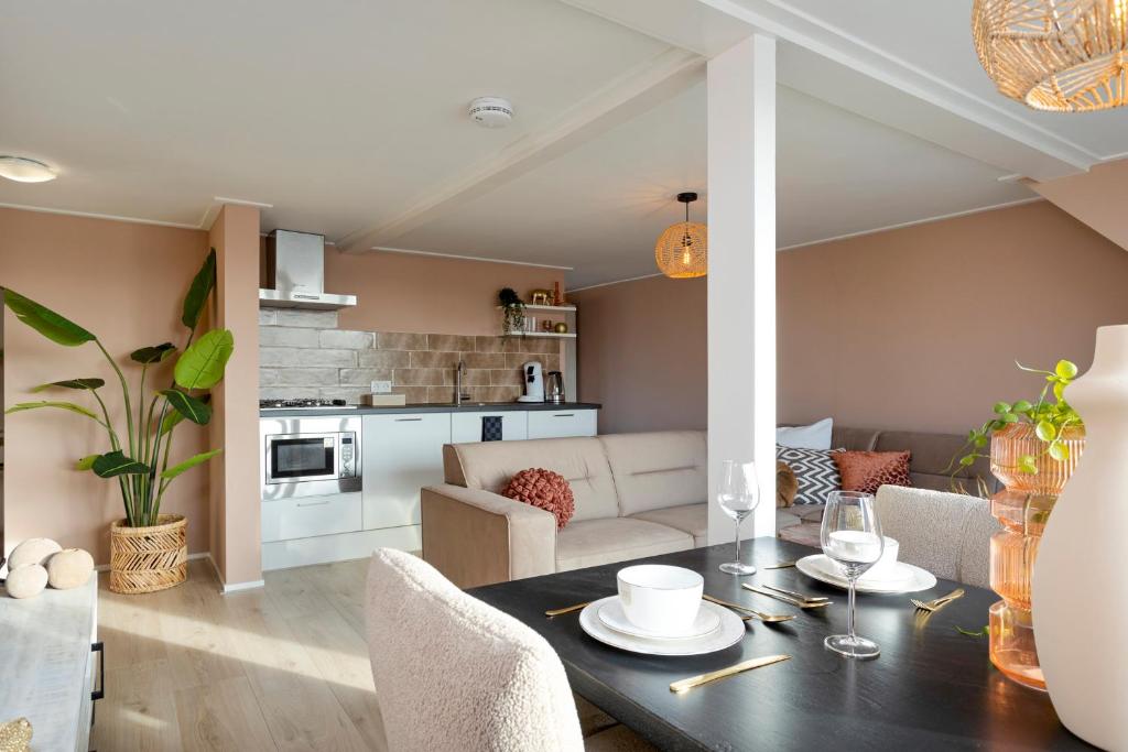 a kitchen and living room with a table and chairs at Enschede81 in Enschede