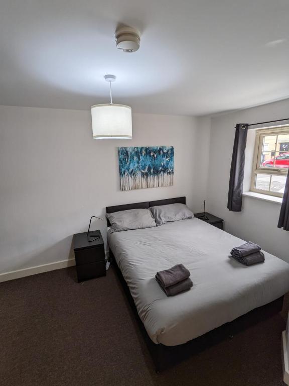 a bedroom with a bed with two pillows on it at Self contained town house in Mexborough in Mexborough
