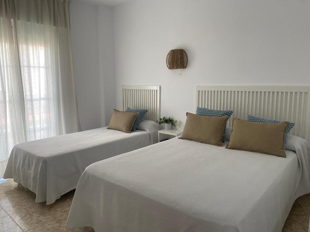 Postel nebo postele na pokoji v ubytování Hostal Andalucia