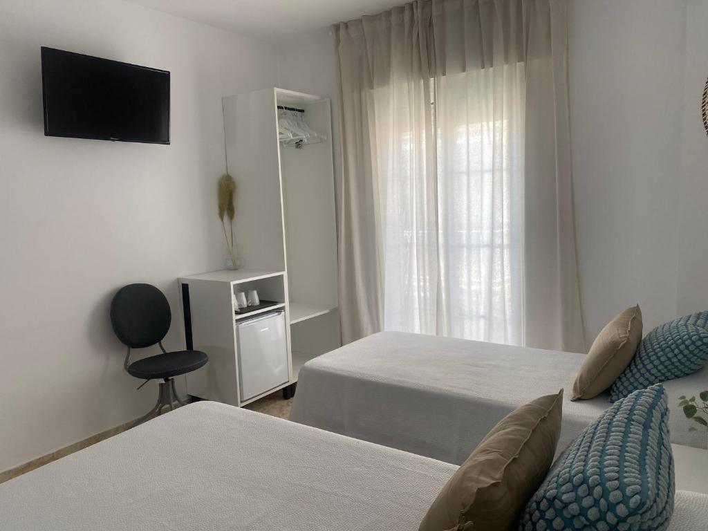 Postel nebo postele na pokoji v ubytování Hostal Andalucia