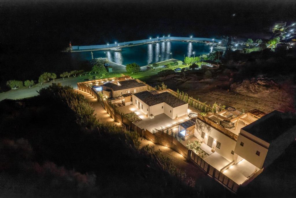 an aerial view of a house at night with a bridge at Mnḗmē Suites & Villas in Kastrí