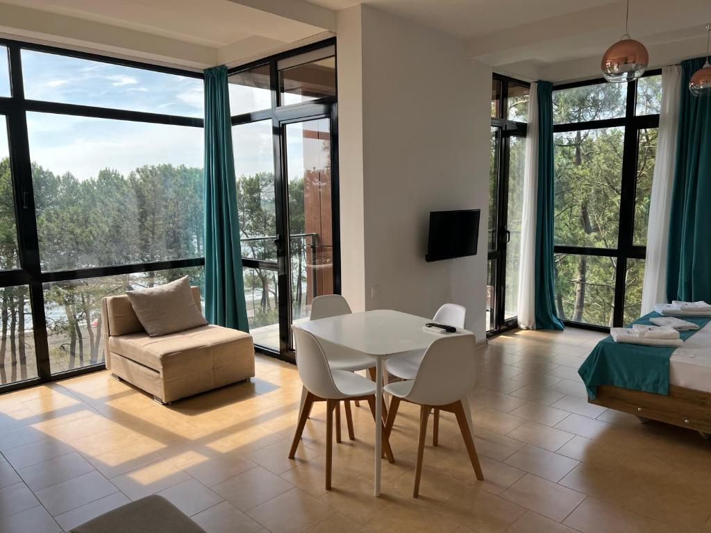 a living room with a table and chairs and a couch at Aparthotel Majak Shekvetili in Shekvetili