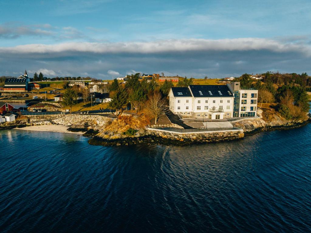 an aerial view of a building on an island in the water at Biologen Herdla in Herlø