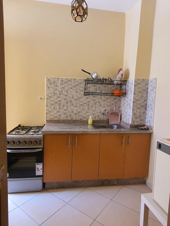a kitchen with a sink and a stove at Marrakech Alal fasi in Marrakesh