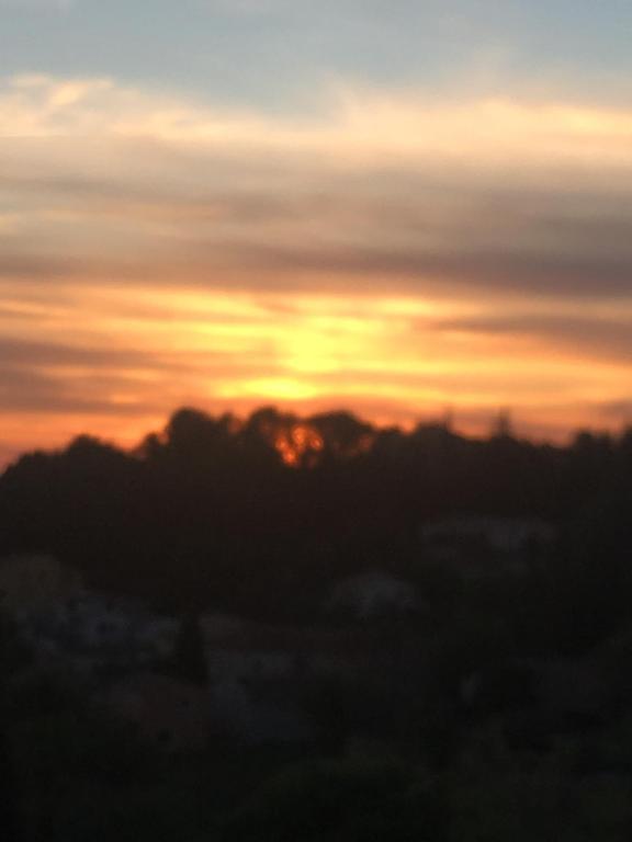 un coucher de soleil avec des nuages dans le ciel dans l'établissement Châteauneuf du Pape - Chez Marie - suite loft au roof top, idéale pour 2 - Vue panoramique, terrasse, Jacuzzi en option, à Châteauneuf-du-Pape