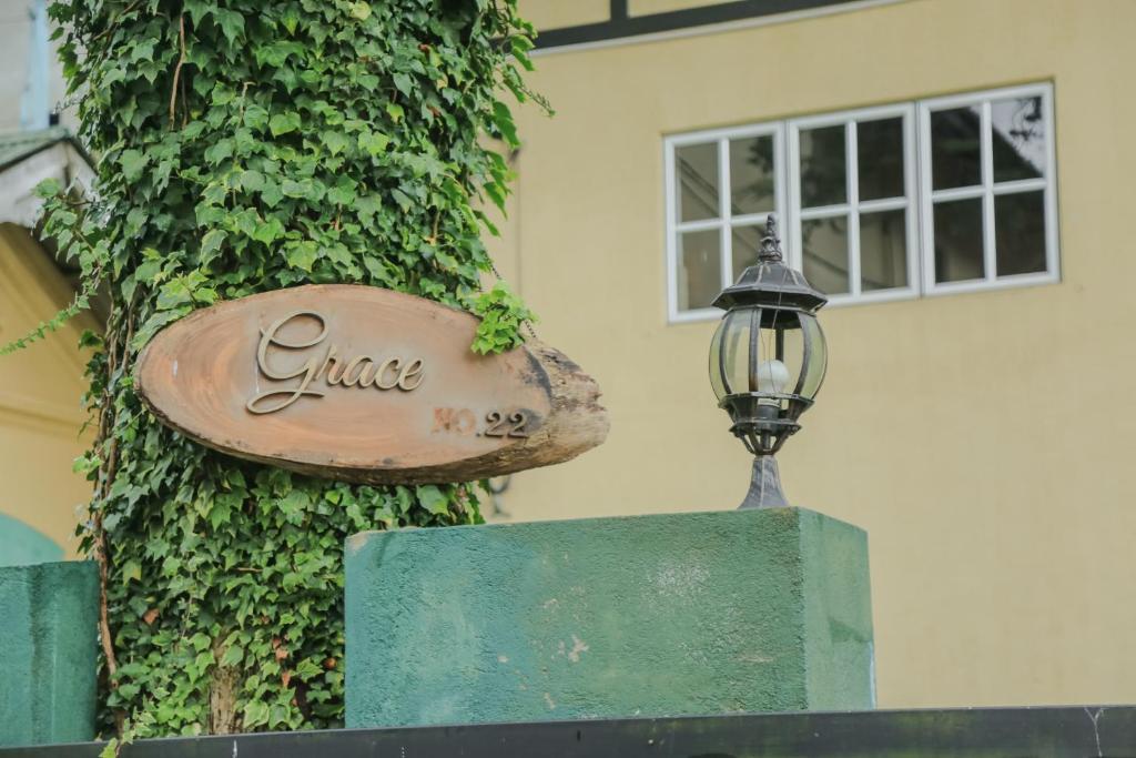 a sign and a street light next to a building at Grace in Nuwara Eliya