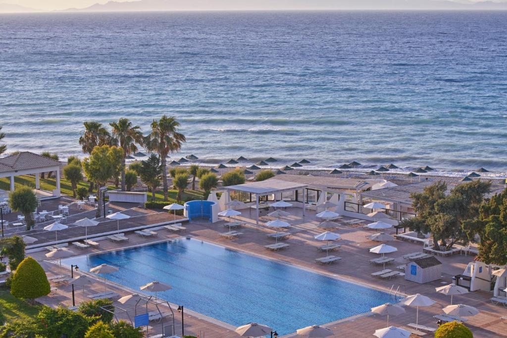 an aerial view of a resort with a swimming pool and the ocean at Labranda Blue Bay Resort in Ialyssos