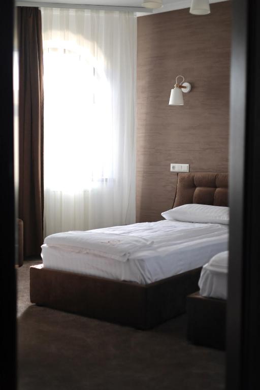 Postel nebo postele na pokoji v ubytování River Stone Hotel