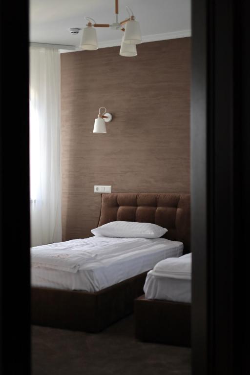 Postel nebo postele na pokoji v ubytování River Stone Hotel