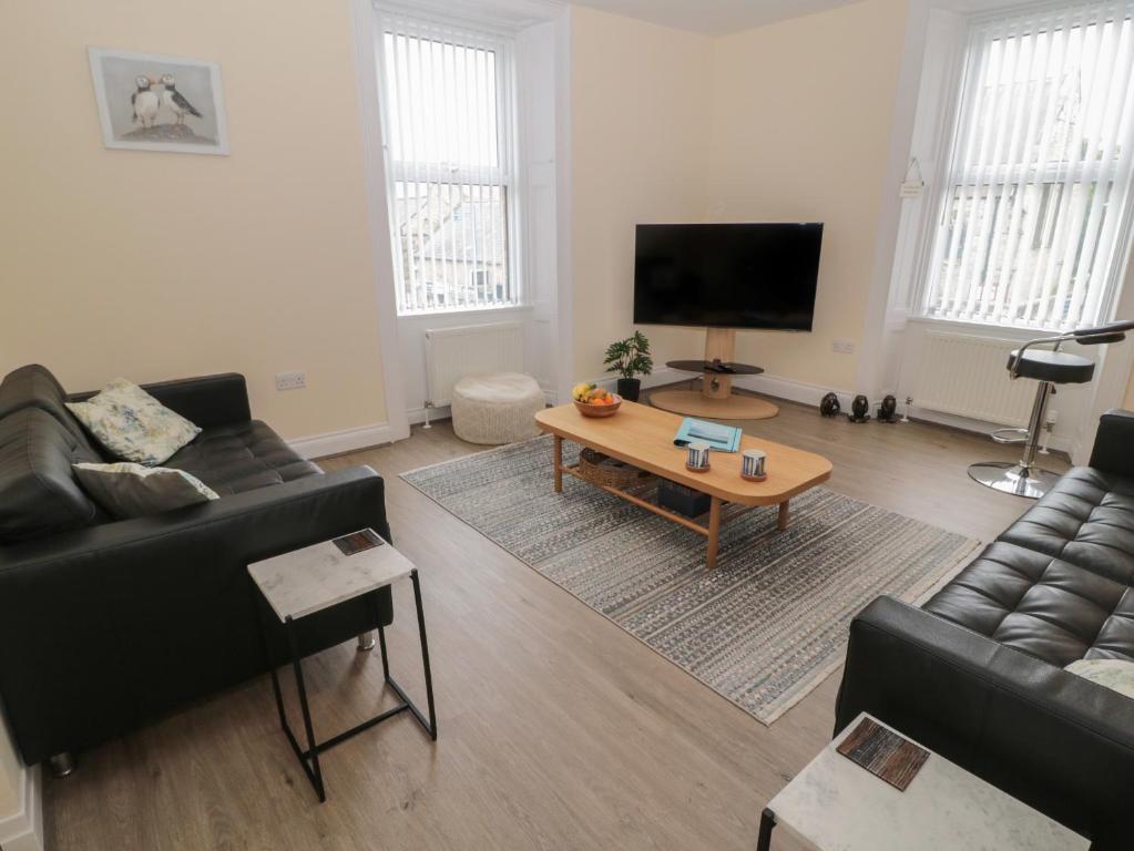 a living room with a couch and a coffee table at Amble Watch in Morpeth