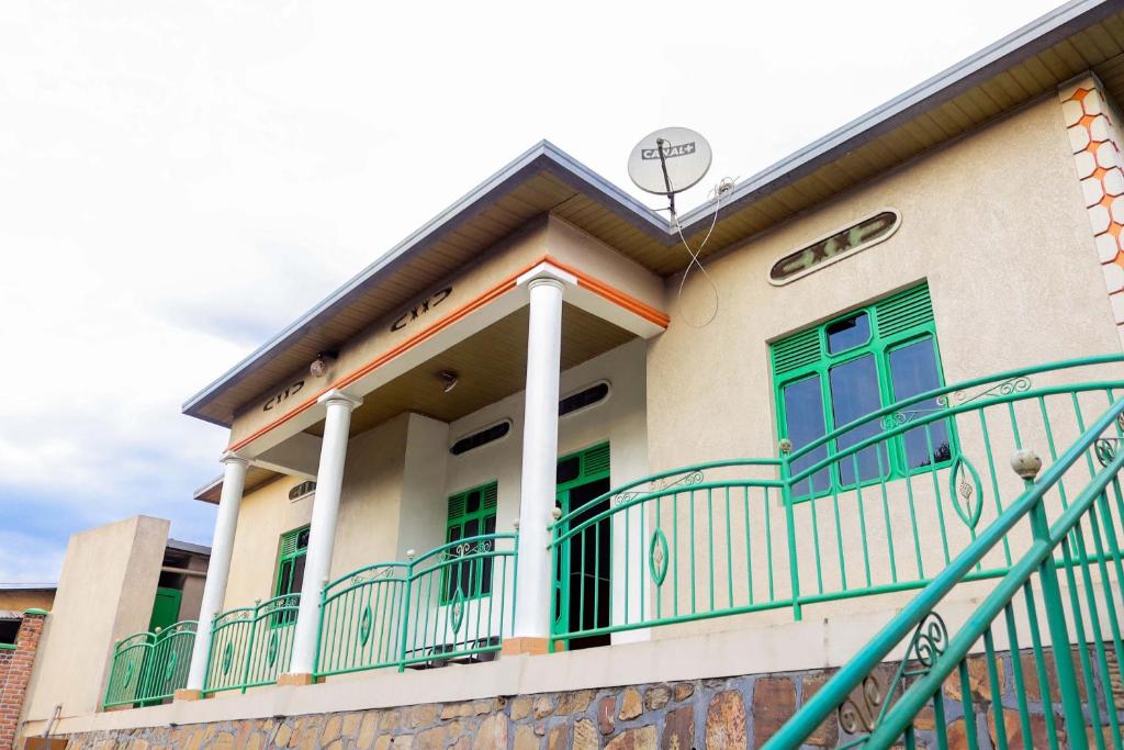 a building with green windows and a balcony at THE PILLAR MOTEL in Kigali