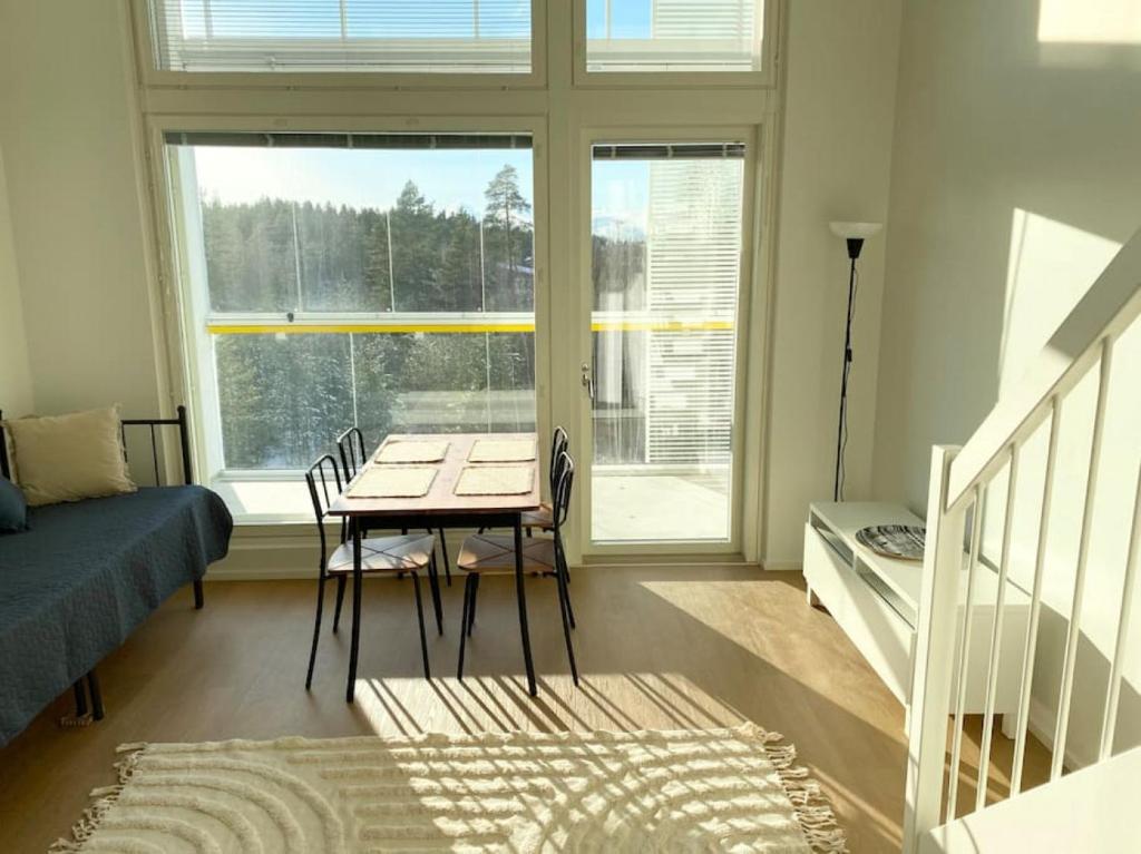 a room with a table and a bed and a window at TUUSULA Tuusula 15 min drive to Airport in Tuusula