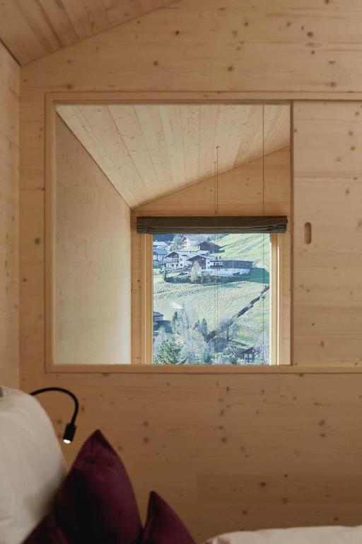 a room with a window in a wooden house at Haus Motta in Gaschurn