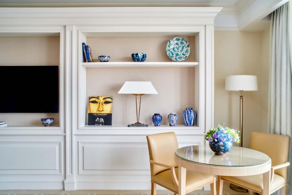 a dining room with a table and a tv at Four Seasons Hotel Cairo at Nile Plaza in Cairo