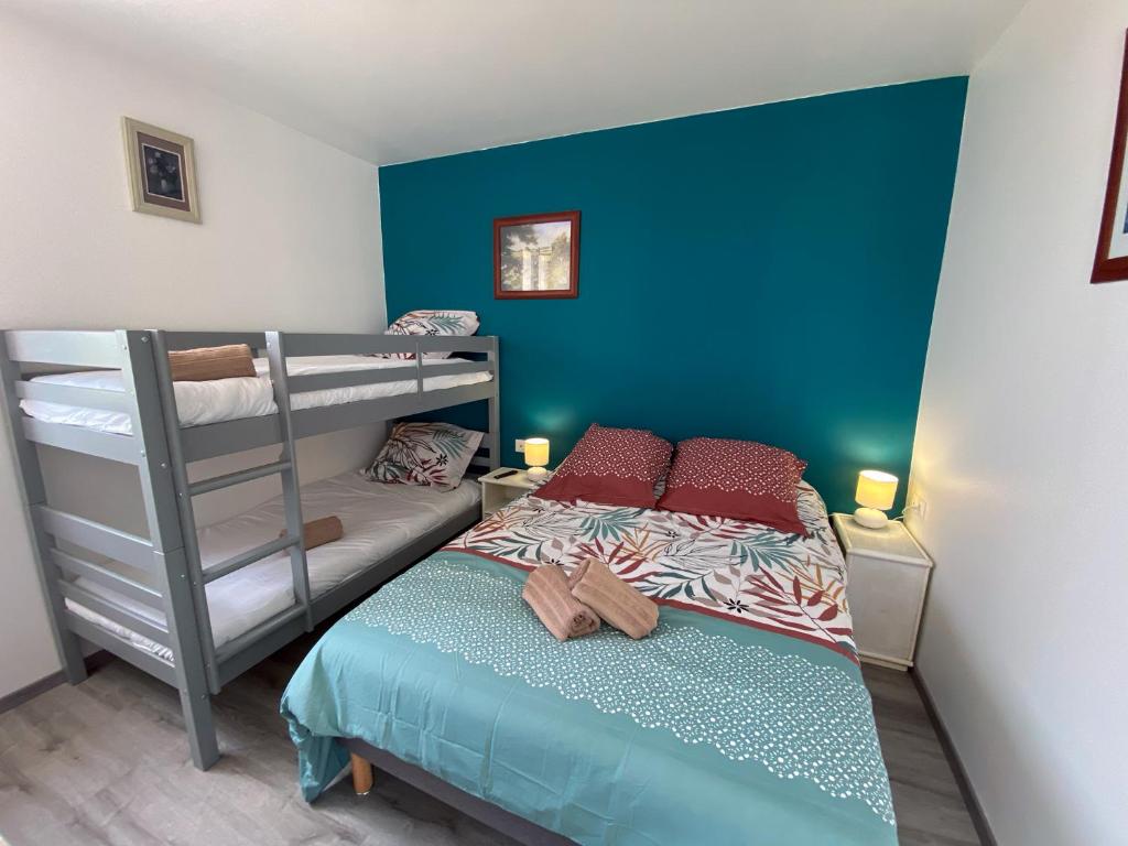 a small bedroom with a bunk bed and a ladder at Auberge des Plaines - Appartements avec terrasse in Arles