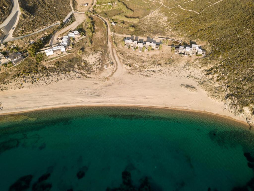 an aerial view of a beach with houses and the water at Ammoa Beach Residences in Vayiá
