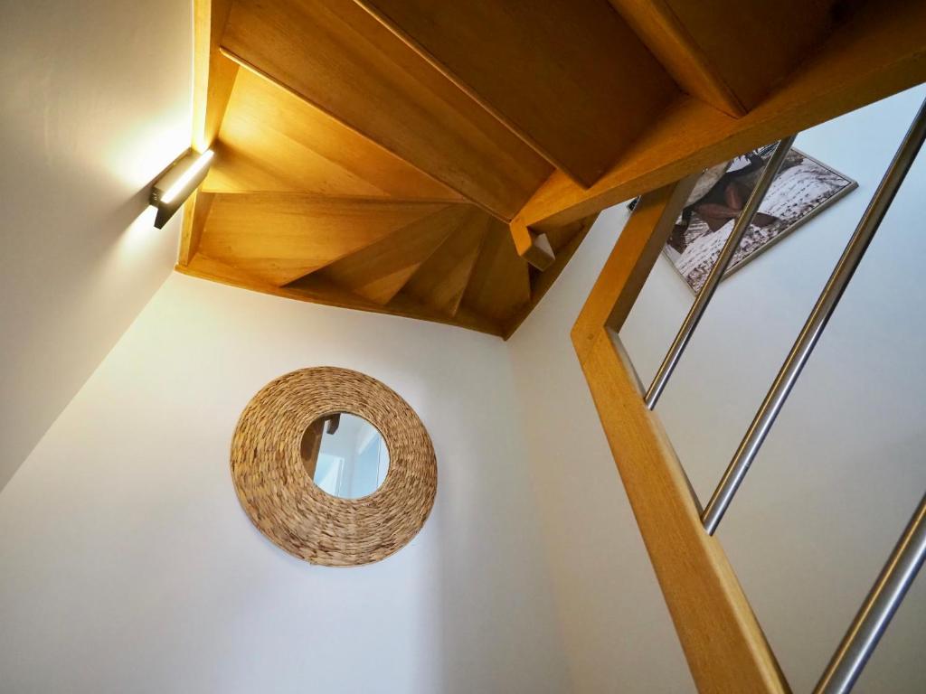 a room with a circular mirror on the wall at 30 m des Plages - Port du Magouër - 6 invités in Plouhinec