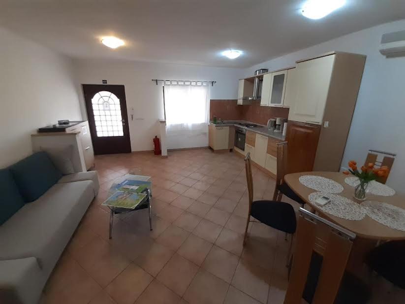 a living room with a couch and a table at APARTMANI DELAS in Pješčana Uvala