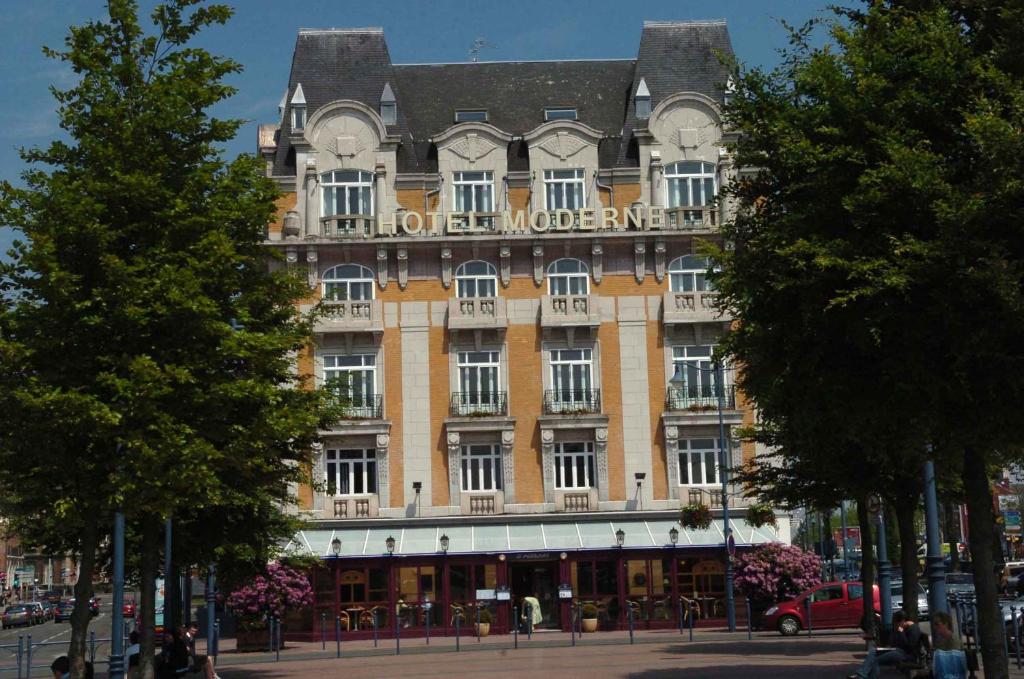 a large building with a sign on the front of it at Hotel Moderne in Arras